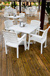 Many white plastic chairs and tables