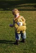 Young boy with dog backpack in park