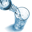 water pouring into glass from bottle isolated on white