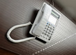 Photo: Telephone over brown desk Telephone over brown desk