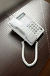 Photo: Telephone over brown desk Telephone over brown desk
