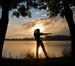 Silhouette of a young woman doing yoga exercise