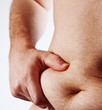 Man holding his fat belly isolated on white