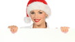 Girl in santa claus hat holding empty board