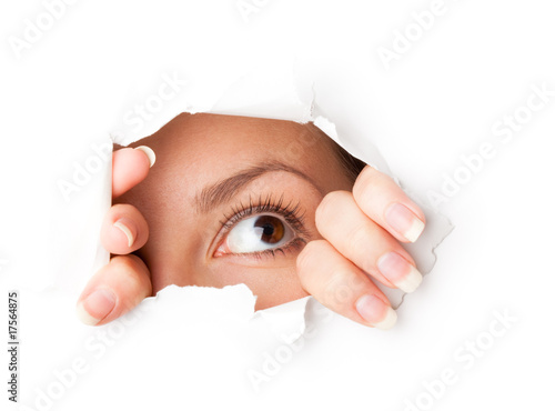 Photo : Eye looking through hole Eye looking through hole