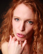 woman with curly red hair looking at camara