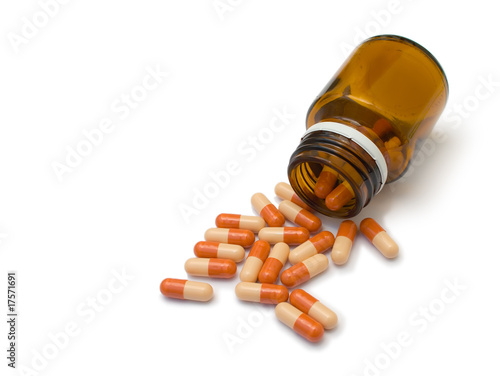 Photo: Omeprazol pills spilling from bottle Omeprazol pills spilling from bottle