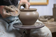 Hands of an artisan working on a potter's wheel