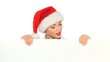 Girl in santa claus hat holding empty board