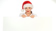 Girl in santa claus hat holding empty board