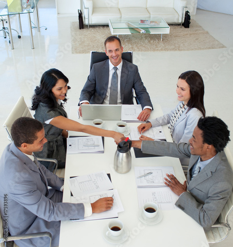 Photo: Businesswoman and businessman shaking hands in a meeting Businesswoman and businessman shaking hands in a meeting