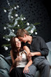 Young extravagant man and woman with champagne on Christmas