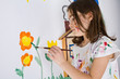 Girl painting on wall
