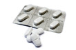 White pills from a packet. Focus on pile in front. White pills from a packet. Focus on pile in front.