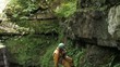 Man descends into a cave viewed from above