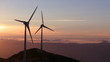 Wind turbine generator in the mountains at sunset