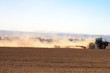 Farm Tractor Moving across dusty field Farm Tractor Moving across dusty field