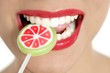 Colorful Lollypop in perfect woman teeth Colorful Lollypop in perfect woman teeth