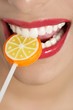 Colorful Lollypop in perfect woman teeth Colorful Lollypop in perfect woman teeth