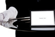 White gloved hand holding a silver tray