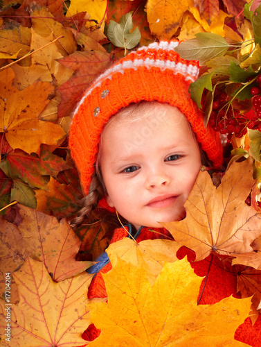 Photo: Girl in autumn orange leaf and red berry. Outdoor. Girl in autumn orange leaf and red berry. Outdoor.