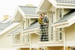 couple on balcony of one-family house