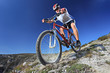 Photo: Person riding a bike downhill style Person riding a bike downhill style