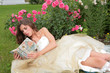 princess with book in hand in the flowers