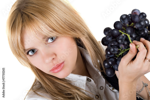 Photo: Portrait of the girl with grapes cluster. Isolated Portrait of the girl with grapes cluster. Isolated
