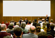 conference hall full of people participating