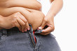 Woman trying hand to zipper her jeans