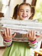 girl recycling newspapers