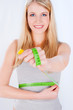 Measure tape around slim woman's waist