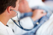 Doctor examining a patient's heart beat with a stethoscope