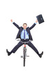 Happy young businessman on a bicycle isolated against white Happy young businessman on a bicycle isolated against white