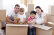 Family moving home with boxes around Family moving home with boxes around