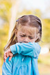 Photo: Young child coughing or sneezing into her elbow. Young child coughing or sneezing into her elbow.