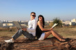 Foto: Portrait of a sweet couple sitting on a log. Portrait of a sweet couple sitting on a log.