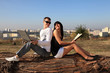 Foto: Portrait of a sweet couple sitting on a log. Portrait of a sweet couple sitting on a log.