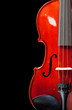 Partial view of a violin on a black