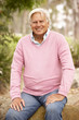 Senior Man Sitting On Wall