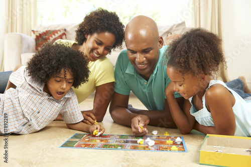 Photo: Family Playing Board Game At Home Family Playing Board Game At Home