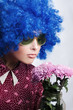 Young beauty clown with flowers