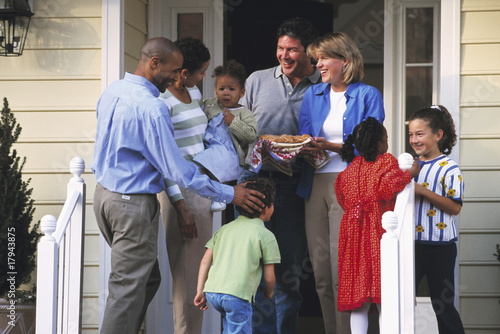 Photo: Two families greeting each other on porch Two families greeting each other on porch