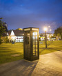 Phone box next to park at night