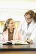 Female science teacher helping teenaged student