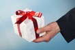 man holiday and offering a gift on his hand