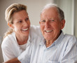 Closeup of a happy old man on the wheel chair with a nurse Closeup of a happy old man on the wheel chair with a nurse