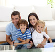 Portrait of happy family smiling in living-room