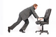 Businessman pushing own swivel chair on his career path Businessman pushing own swivel chair on his career path